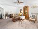 A cozy living room with plush carpeting, neutral walls, and a ceiling fan for added comfort at 6630 Bubbling Brook Dr # C, Las Vegas, NV 89107