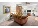 A well-lit living room with a ceiling fan, large window, and traditional furniture offers a cozy atmosphere at 6630 Bubbling Brook Dr # C, Las Vegas, NV 89107