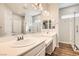 Bright bathroom with double sink vanity, large mirrors, and a walk-in shower at 668 Look Lively Ct, Henderson, NV 89011