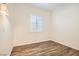 A light, airy bedroom featuring wood floors, plantation shutters and neutral paint at 668 Look Lively Ct, Henderson, NV 89011