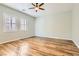 Spacious bedroom with neutral walls, wood floors, shutters, and modern ceiling fan at 668 Look Lively Ct, Henderson, NV 89011