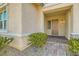 Close-up view of the front door entry, surrounded by lush shrubbery and a charming brick walkway at 668 Look Lively Ct, Henderson, NV 89011