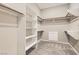 A walk-in closet featuring carpeted floors, shelves, hanging rods, and built-in storage at 668 Look Lively Ct, Henderson, NV 89011