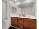 Bathroom with wooden vanity cabinet and double sinks at 6988 Sylmar Ave, Las Vegas, NV 89113