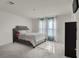 Bedroom with a plush bed, large window, and gray carpeting at 6988 Sylmar Ave, Las Vegas, NV 89113