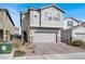 Two-story home showcasing a two-car garage, neutral stucco, and a paved driveway with desert landscaping at 6988 Sylmar Ave, Las Vegas, NV 89113