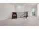 Open landing area with neutral carpet and wrought iron banister at 6988 Sylmar Ave, Las Vegas, NV 89113