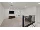 Carpeted hallway with wrought iron banister, television and comfortable chair at 6988 Sylmar Ave, Las Vegas, NV 89113