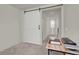 Hallway featuring neutral walls, a sliding barn door, and natural light filtering through a nearby window at 6988 Sylmar Ave, Las Vegas, NV 89113