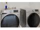 Modern laundry room with side-by-side washer and dryer units at 6988 Sylmar Ave, Las Vegas, NV 89113