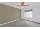 Cozy bedroom with ceiling fan, neutral color palette and large window at 7100 Pirates Cove Rd # 2067, Las Vegas, NV 89145