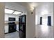 Modern kitchen view from living room; featuring sleek black appliances at 7100 Pirates Cove Rd # 2067, Las Vegas, NV 89145