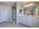 Bright bathroom featuring double vanity, large mirror, and a glass-enclosed shower at 720 Sleeping City Ave, Henderson, NV 89015