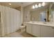 Neutral bathroom with white cabinets, a framed mirror and a shower with white shower curtain at 720 Sleeping City Ave, Henderson, NV 89015