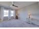 Bright bedroom features plush carpeting, a ceiling fan, and natural light from the windows at 720 Sleeping City Ave, Henderson, NV 89015