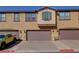 Townhome with a three car garage, brick drive and low water landscaping at 720 Sleeping City Ave, Henderson, NV 89015