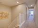 Upstairs hallway with neutral carpet and paint leading to bedrooms, complete with white railing at 720 Sleeping City Ave, Henderson, NV 89015