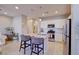 Modern kitchen with stainless steel appliances, island with seating, pendant lighting, and bright white cabinets at 720 Sleeping City Ave, Henderson, NV 89015