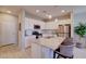 Stylish kitchen featuring white cabinets, stainless steel appliances, a central island with seating, and pendant lights at 720 Sleeping City Ave, Henderson, NV 89015