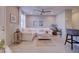 Open concept living room with tile floors, ceiling fan, and a large white sofa with decorative pillows at 720 Sleeping City Ave, Henderson, NV 89015