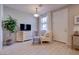 Cozy living room featuring neutral tones, wood-look tile floors, and comfortable seating with natural light at 720 Sleeping City Ave, Henderson, NV 89015