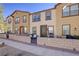 Neighborhood street view of modern townhomes with well-kept landscaping at 720 Sleeping City Ave, Henderson, NV 89015