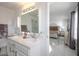 Bathroom featuring double sinks and a doorway view to an adjacent bedroom at 7400 Wheat Grass Ct, Las Vegas, NV 89129