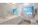 Bright bathroom featuring a double vanity, tile floor and shower at 7400 Wheat Grass Ct, Las Vegas, NV 89129