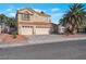 Charming two-story home features a three-car garage and mature landscaping, including palm trees at 7400 Wheat Grass Ct, Las Vegas, NV 89129