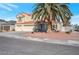 This lovely two-story home boasts a three-car garage and mature landscaping, including a large palm tree at 7400 Wheat Grass Ct, Las Vegas, NV 89129