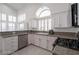 Modern kitchen with white cabinets, granite countertops, stainless steel appliances and natural light at 7400 Wheat Grass Ct, Las Vegas, NV 89129