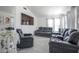 This bright living room features elegant marble floors, a large TV, and luxurious seating at 7400 Wheat Grass Ct, Las Vegas, NV 89129