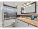 Bathroom with tile floors, granite countertops, and a large mirror at 7436 Lattimore Dr, Las Vegas, NV 89128