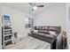 Bedroom with gray hardwood floors, a large window, couch, and ladder at 7436 Lattimore Dr, Las Vegas, NV 89128