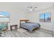 Bedroom with two windows, hardwood floors, a ceiling fan, and natural light at 7436 Lattimore Dr, Las Vegas, NV 89128