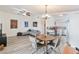 Open concept living space featuring wood-look flooring, modern lighting, and a view of the updated kitchen at 7436 Lattimore Dr, Las Vegas, NV 89128