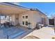 Cozy covered patio with outdoor seating, a stylish rug, and direct access to the home through elegant French doors at 7436 Lattimore Dr, Las Vegas, NV 89128