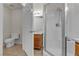 Bright bathroom features a tiled shower and vanity with a wood-grain cabinet at 7701 W Robindale Rd # 102, Las Vegas, NV 89113