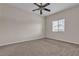 Neutral carpeted bedroom with ceiling fan and bright natural light from the window at 7701 W Robindale Rd # 102, Las Vegas, NV 89113