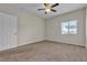 Standard bedroom with a ceiling fan, a window, and carpeted floor at 7701 W Robindale Rd # 102, Las Vegas, NV 89113