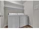 A laundry room featuring a white washer and dryer with shelving at 7701 W Robindale Rd # 102, Las Vegas, NV 89113