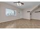 Inviting living room featuring bright windows, neutral walls, and a ceiling fan, creating a cozy atmosphere at 7701 W Robindale Rd # 102, Las Vegas, NV 89113