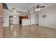 Open-concept living room with tile flooring, a ceiling fan, seamlessly flowing into the kitchen at 7701 W Robindale Rd # 102, Las Vegas, NV 89113