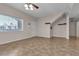 Inviting living room featuring bright windows, neutral walls, and a ceiling fan, creating a comfortable space at 7701 W Robindale Rd # 102, Las Vegas, NV 89113