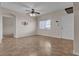 Cozy living room with tile flooring, ceiling fan, and natural light, offering a comfortable living space at 7701 W Robindale Rd # 102, Las Vegas, NV 89113