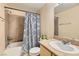 Bright bathroom featuring a granite vanity top, a patterned shower curtain, and shower-tub combination at 8000 W Badura Ave # 1019, Las Vegas, NV 89113