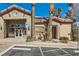 Well-manicured clubhouse exterior with ample parking and desert landscaping at 8000 W Badura Ave # 1019, Las Vegas, NV 89113