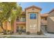 Inviting two-story condo with colorful facade, well-manicured landscaping and stairs to upper units at 8000 W Badura Ave # 1019, Las Vegas, NV 89113