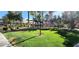 Exterior view of lush green lawn and trees creating a park-like setting for the residence at 8000 W Badura Ave # 1019, Las Vegas, NV 89113