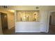 Neutral living space looking into the kitchen through a half wall at 8000 W Badura Ave # 1019, Las Vegas, NV 89113